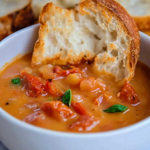 Comforting meal showing golden-brown toasted bread beside the bowl.