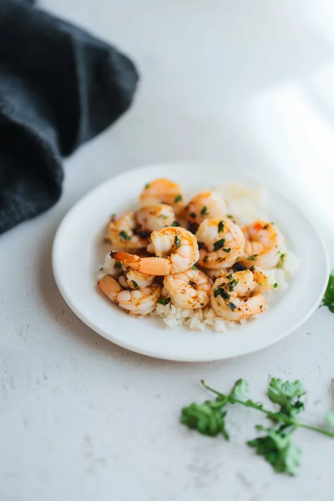Tender shrimp glistening with garlic butter, served over a bed of warm rice.