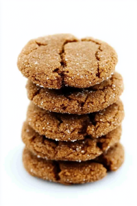 Freshly baked gingersnap cookies stacked together with warm spice flavors.