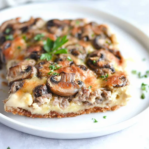 Savory comfort food served on a white plate, highlighting rich textures and browned edges.