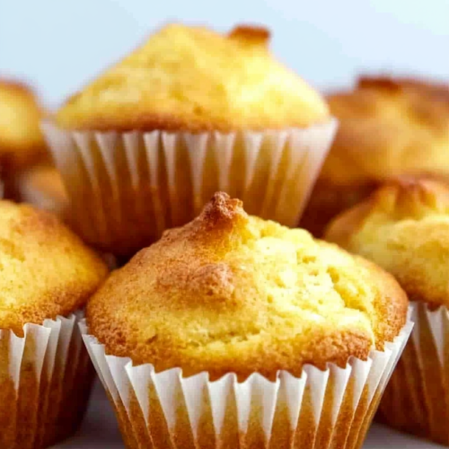Close-up of moist cornbread muffins showing fluffy texture and warm color.