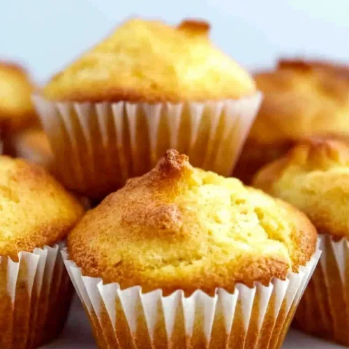 Close-up of moist cornbread muffins showing fluffy texture and warm color.