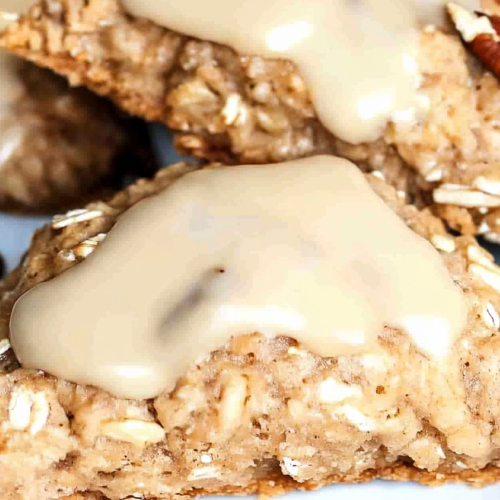 Homemade baked scones with hearty oats and pecans finished with a sweet creamy glaze