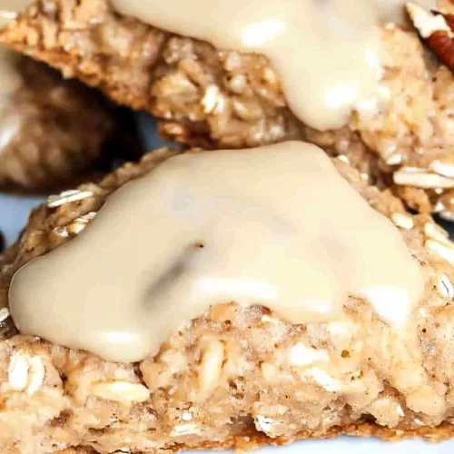 Homemade baked scones with hearty oats and pecans finished with a sweet creamy glaze