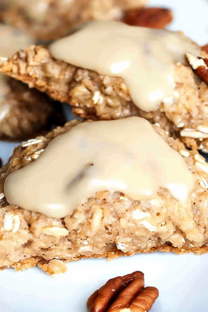 Homemade baked scones with hearty oats and pecans finished with a sweet creamy glaze
