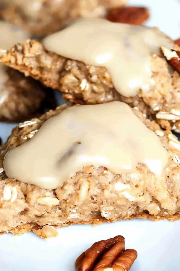 Homemade baked scones with hearty oats and pecans finished with a sweet creamy glaze