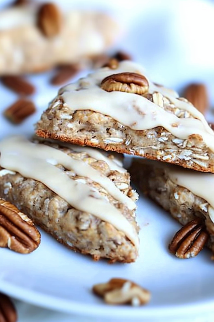 Rustic oat and pecan pastries served with maple frosting and a soft tender texture inside