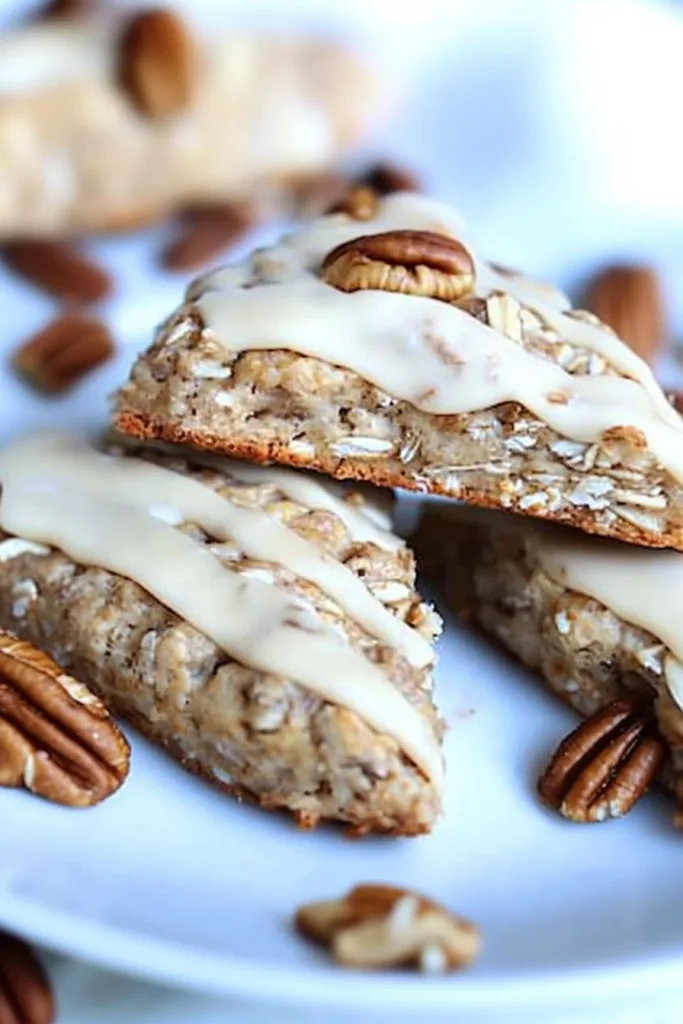 Rustic oat and pecan pastries served with maple frosting and a soft tender texture inside