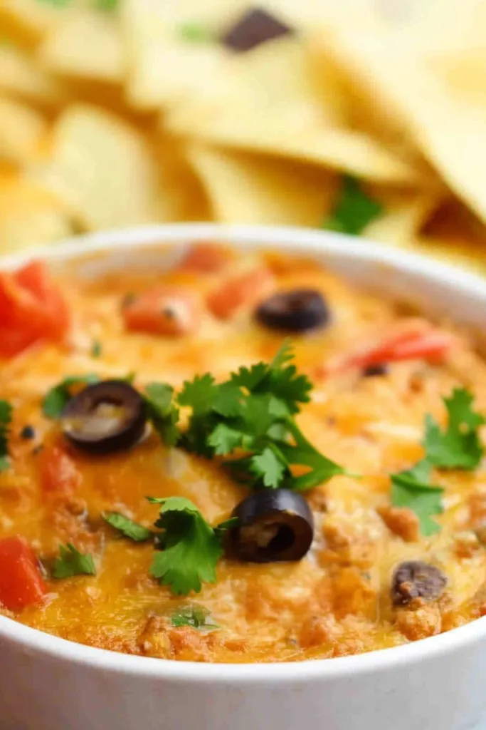 Rich orange-brown dip topped with herbs, highlighting its warm texture.