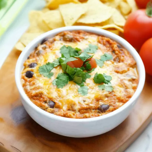 Cheesy baked appetizer presented with crisp chips for a festive snack.