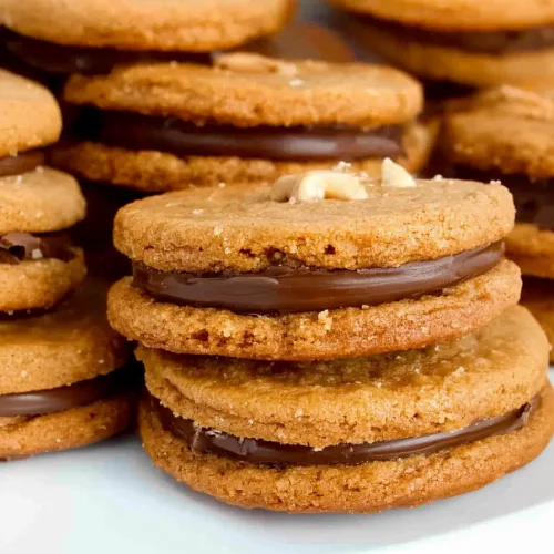 Homemade peanut butter sandwich cookies layered with smooth milk chocolate filling and baked until golden