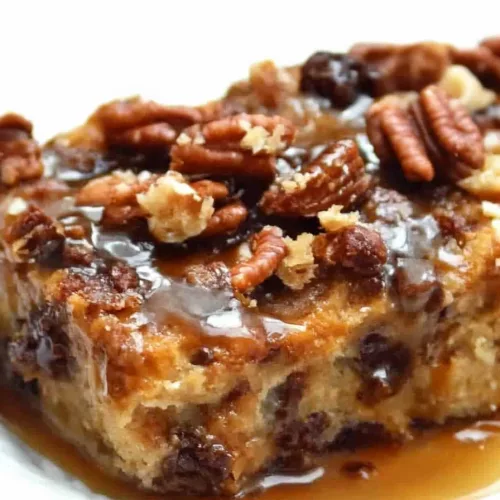 Indulgent bread pudding presentation with pecans and caramel sauce for a homemade look.