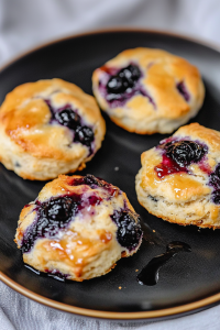 Freshly baked biscuits arranged together, highlighting their soft, buttery texture.