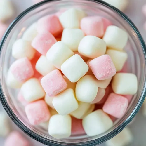 Closeโup of smooth pastel candies, delicate colors highlighted against a bright background.