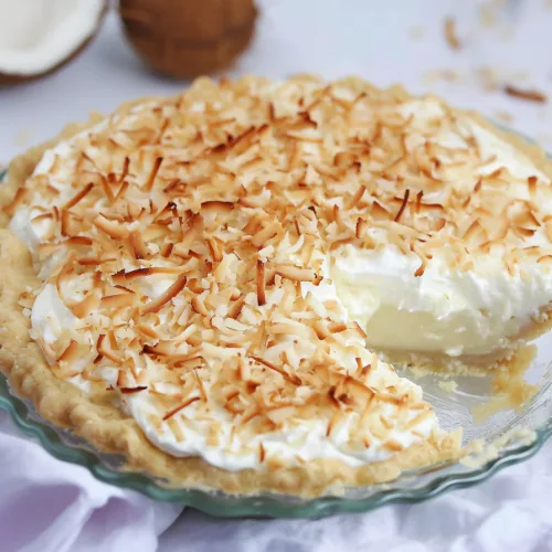 Dessert presentation highlighting the contrast between silky cream and crunchy coconut topping.