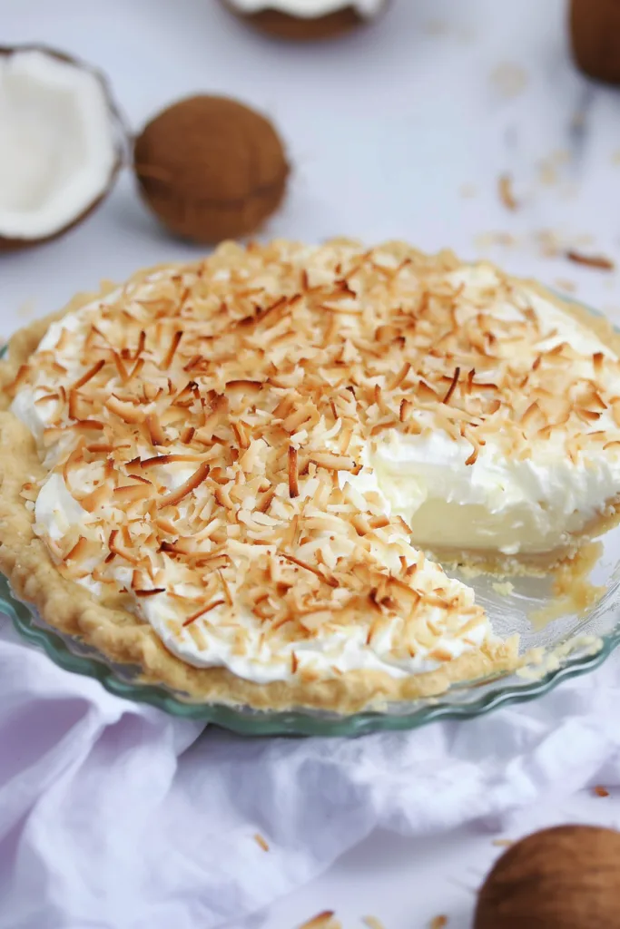 Dessert presentation highlighting the contrast between silky cream and crunchy coconut topping.