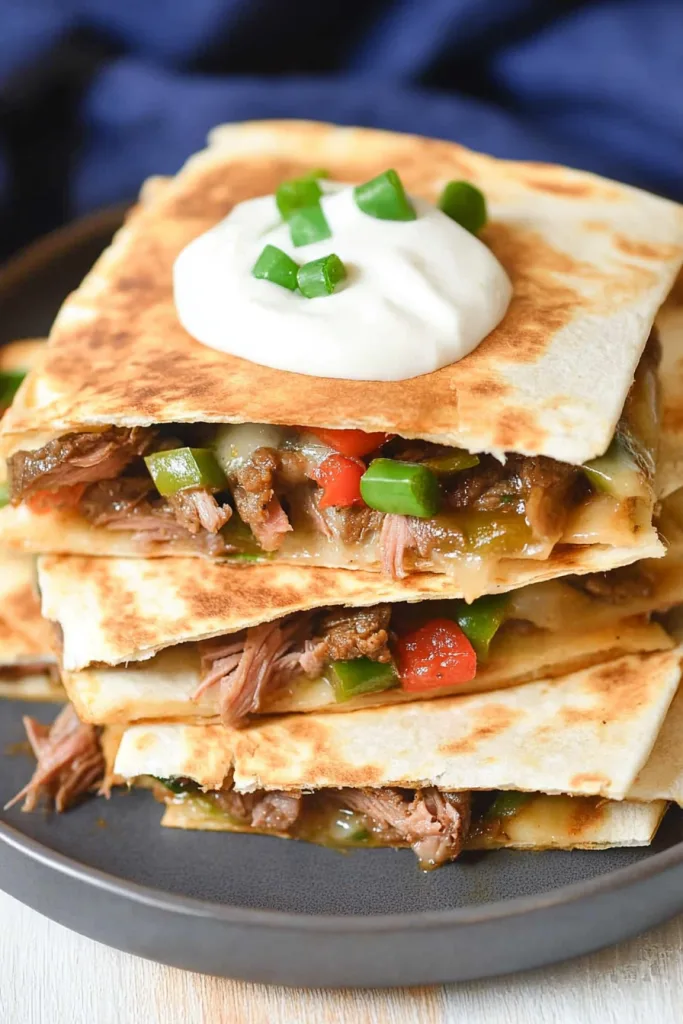 Crispy tortilla edges framing tender steak and colorful bell peppers inside.