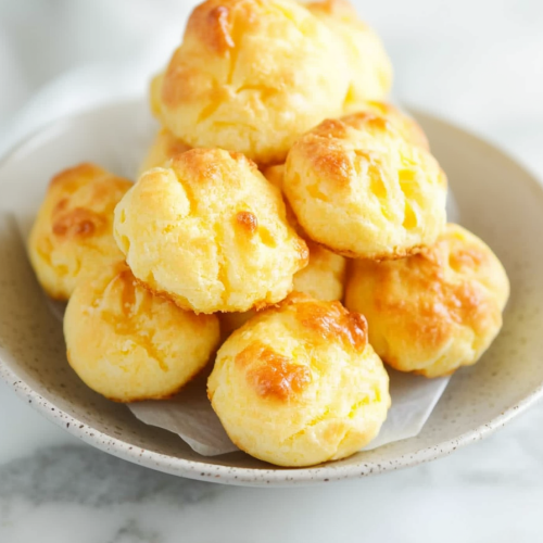 Round pastries with a glossy finish, presented simply against a neutral background.