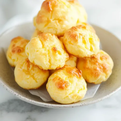 Round pastries with a glossy finish, presented simply against a neutral background.