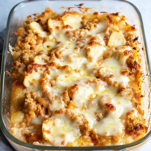 Baked pasta casserole with golden breadcrumb crust and melted cheese bubbling on top.
