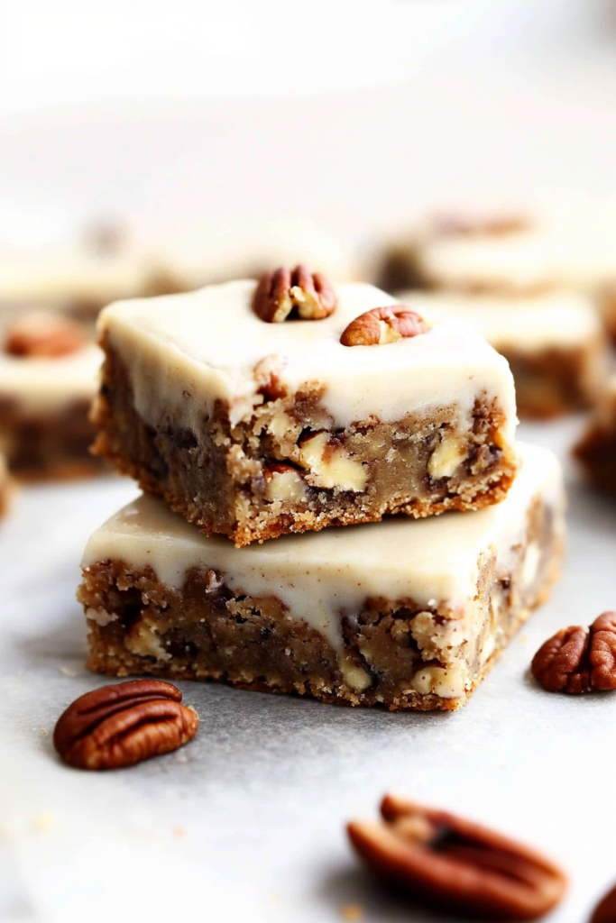 Rich, textured cake topped with smooth frosting and crunchy pecans.