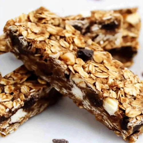 Close-up of granola bar texture highlighting melted chocolate and crunchy oats.