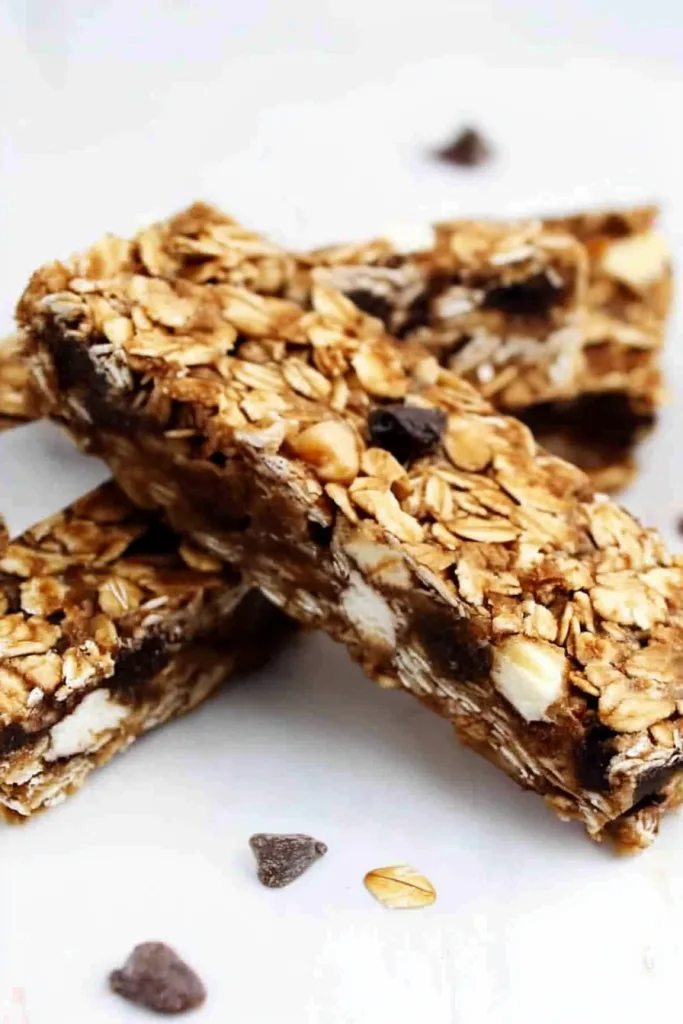Close-up of granola bar texture highlighting melted chocolate and crunchy oats.