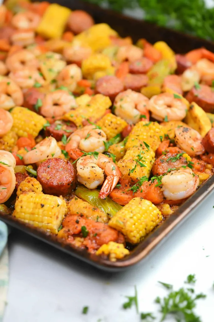 Roasted shrimp and sausage with sweet corn and fresh herbs on a sheet pan