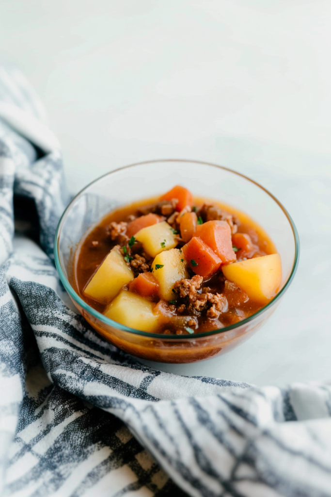 Comforting homemade stew showing chunks of carrots and golden potatoes.