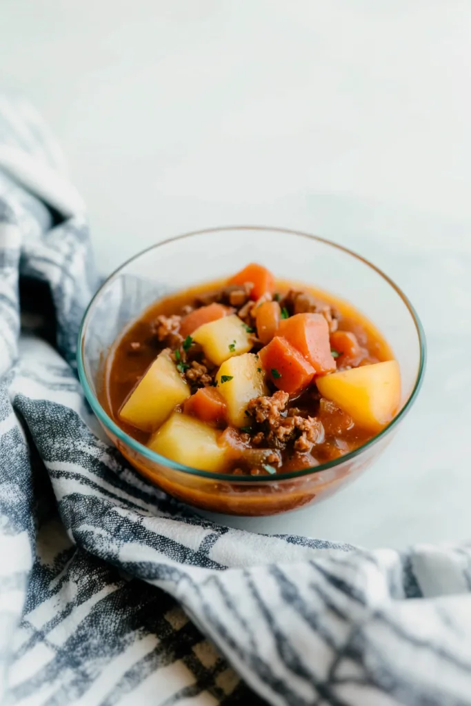 Comforting homemade stew showing chunks of carrots and golden potatoes.