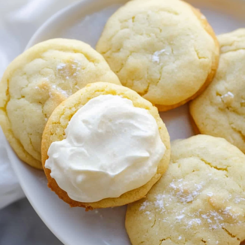 Tender sugar cookies with a light dusting of powdered sugar and smooth icing.