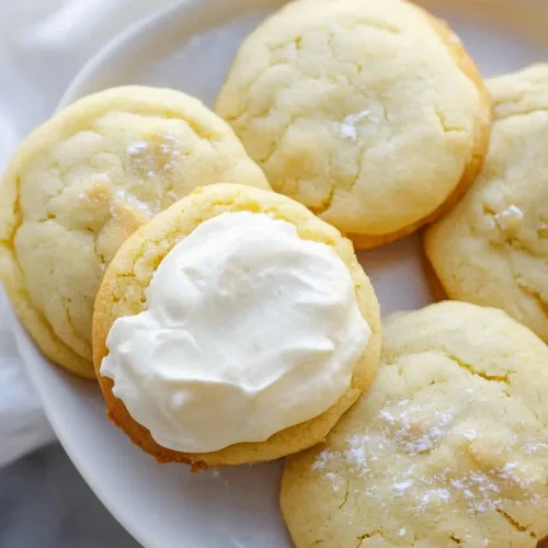 Tender sugar cookies with a light dusting of powdered sugar and smooth icing.