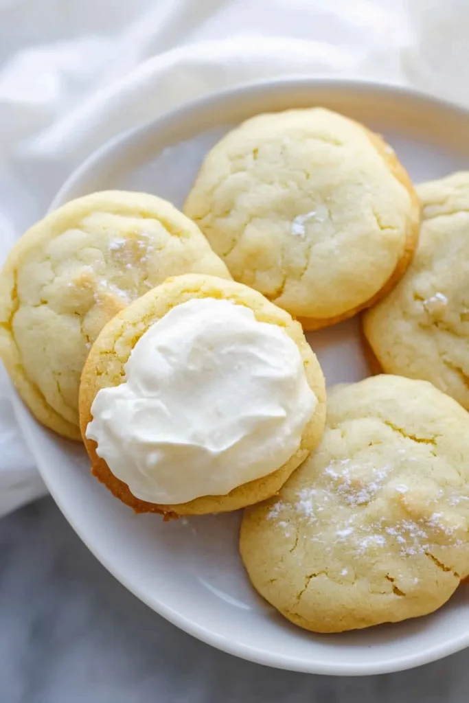 Tender sugar cookies with a light dusting of powdered sugar and smooth icing.