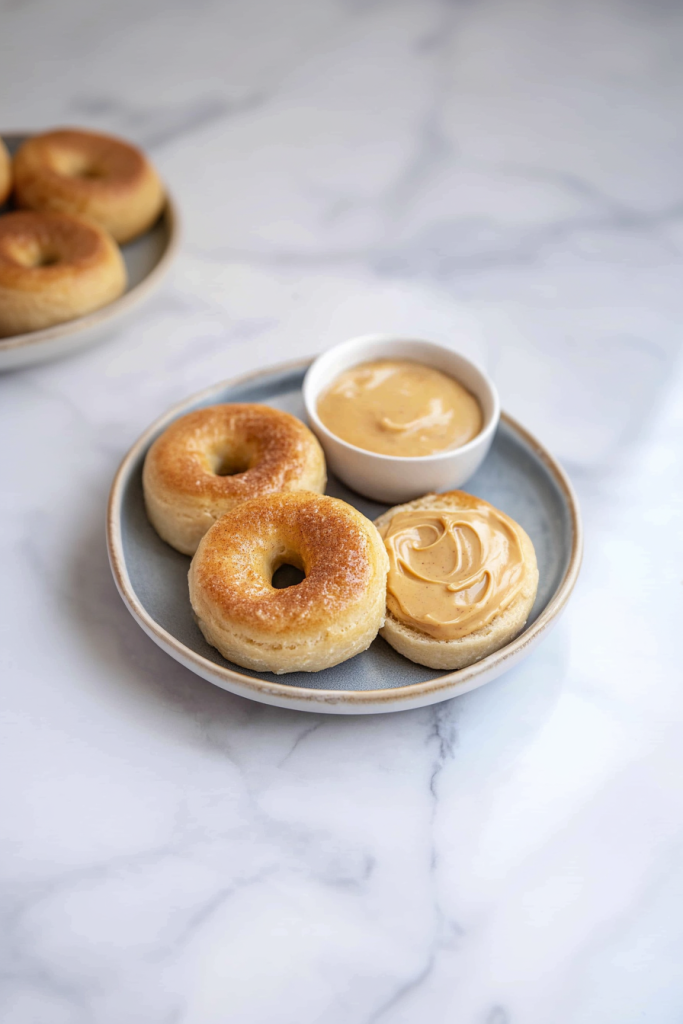 Soft, pillowy rolls on a marble surface with a bowl of honey butter for dipping.