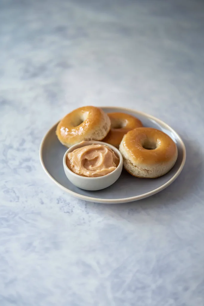 Texas Roadhouse Rolls served warm with honey cinnamon butter in a white dish.