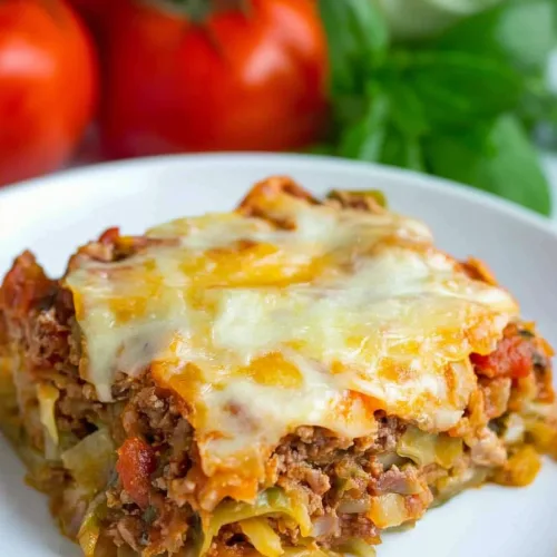 Rich casserole slice showing cheese, cabbage, and tomato filling