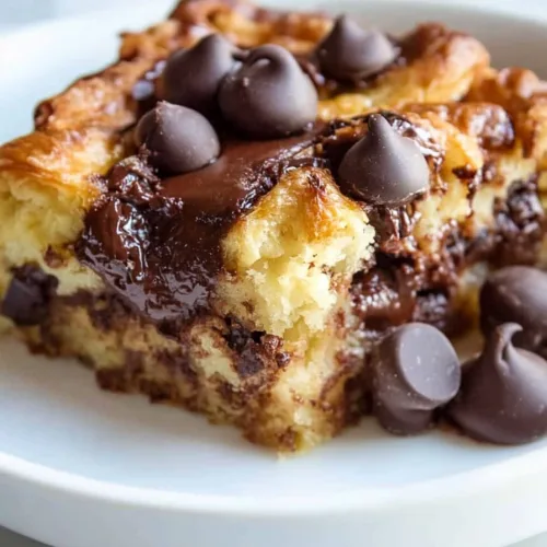 Moist, fluffy croissant layers baked together with melted chocolate, creating a decadent texture.