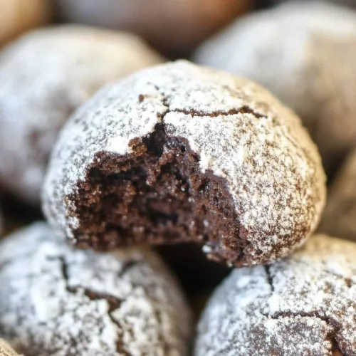 Stack of chocolate cookies dusted in sugar, festive and inviting