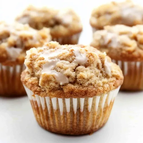 Freshly baked muffin showing crunchy streusel texture and shiny glaze detail.