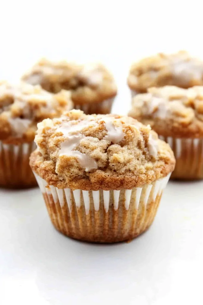 Freshly baked muffin showing crunchy streusel texture and shiny glaze detail.
