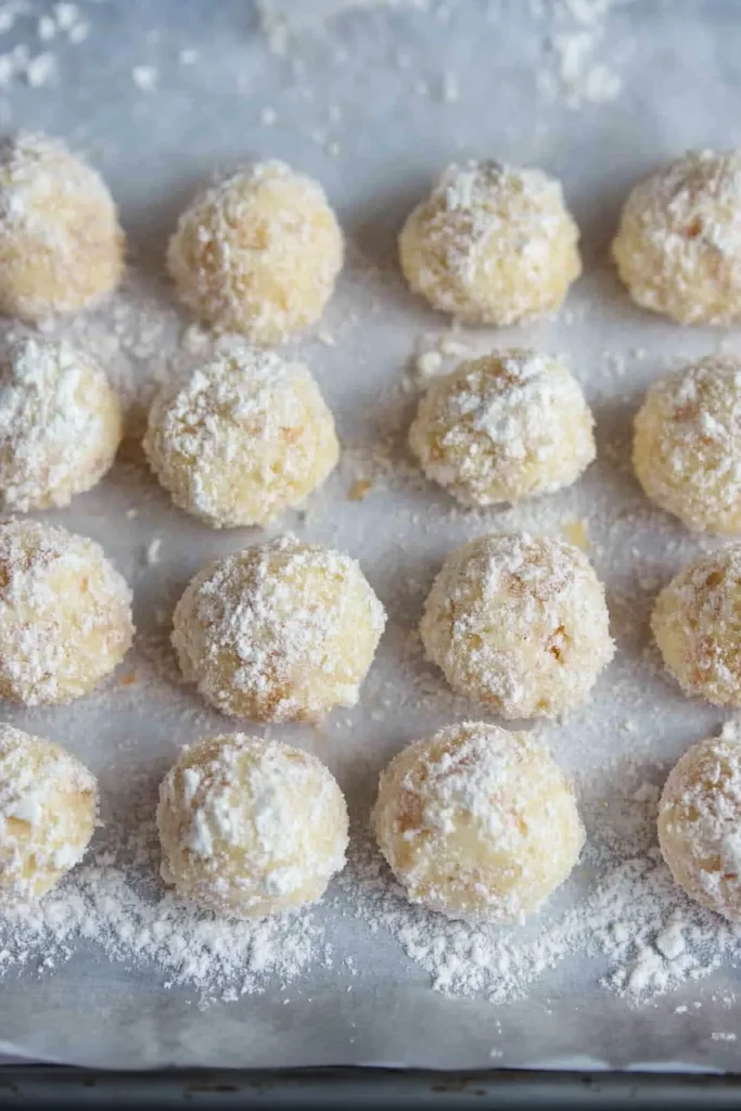 Freshly baked snowball cookies arranged neatly, soft and delicate.