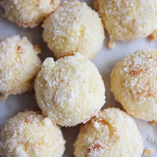 Cream Cheese Snowball Cookies presented with a light sugar dusting.