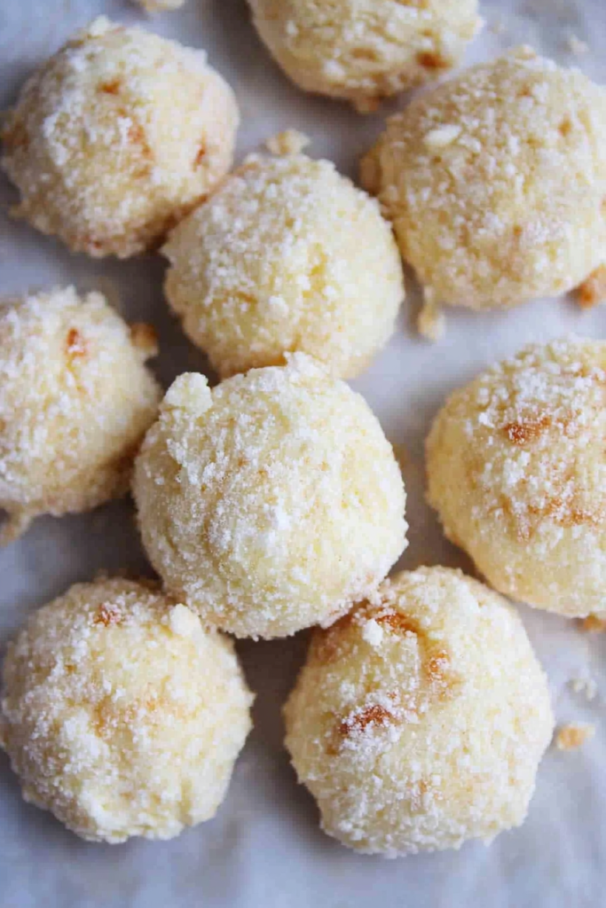 Cream Cheese Snowball Cookies presented with a light sugar dusting.