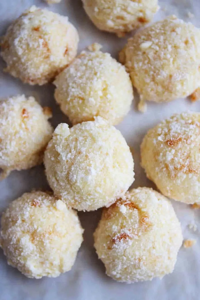 Cream Cheese Snowball Cookies presented with a light sugar dusting.