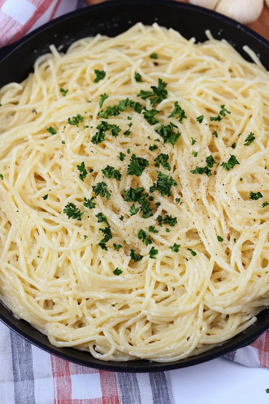 Fresh parsley sprinkled over silky pasta in light sauce