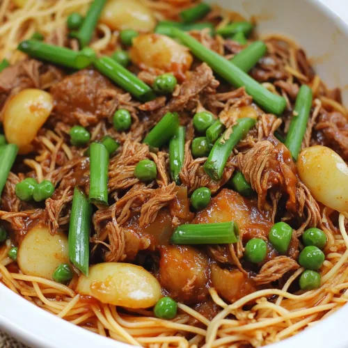 Colorful noodle dish with peas, onions, and leafy greens