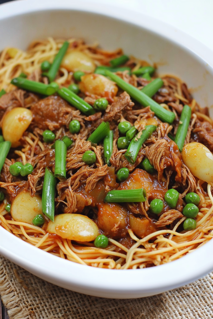 Colorful noodle dish with peas, onions, and leafy greens