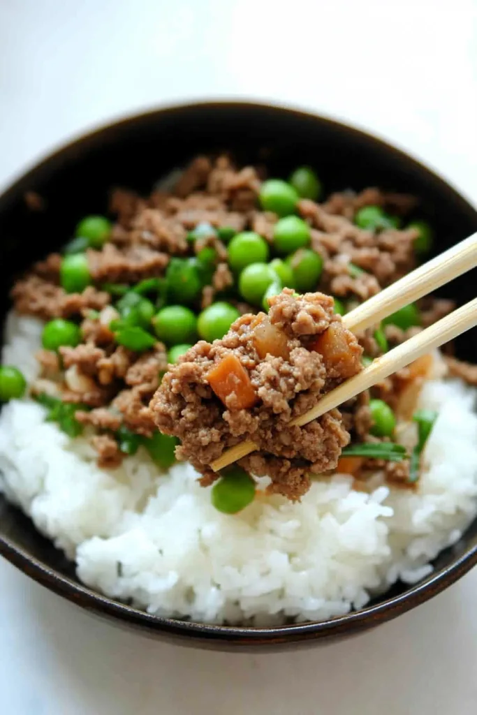 Overhead view of the finished donburi, showing grains, protein, and garnish together.