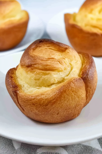 Close-up of fluffy baked pudding highlighting its rise and texture.