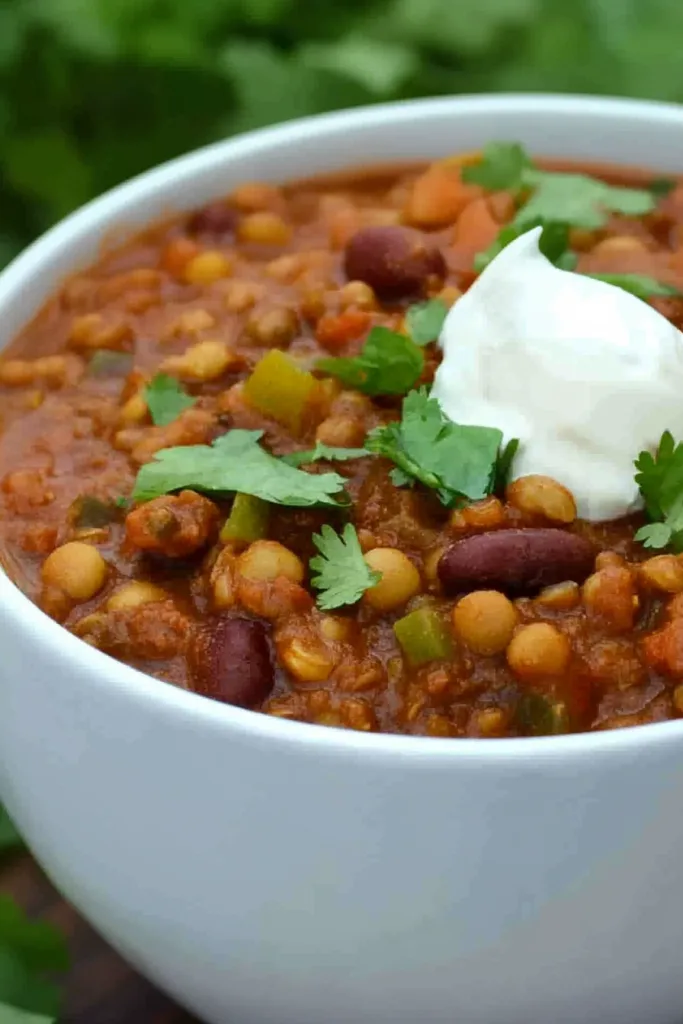 Close-up of thick tomato-based chili with beans and lentils.